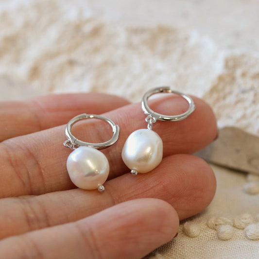 Shan&Co's Gold/Silver Pearl Drop Hoop Earrings and Pearl Pendant Huggies Earrings featuring lustrous pearls suspended from sleek gold or silver settings, offering a timeless and elegant design perfect for any occasion.