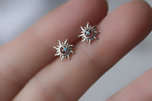 Shan&Co's Sterling Silver/Gold Vermeil Starburst Stud Earrings, featuring a radiant starburst design, paired with Blue Opal Sunburst Studs for a celestial-inspired look. Crafted in high-quality sterling silver or gold vermeil.